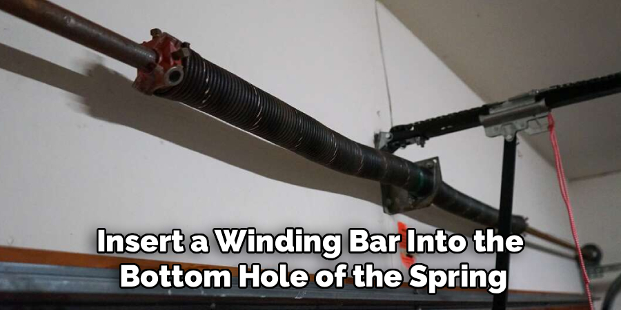 Insert a Winding Bar Into the
Bottom Hole of the Spring