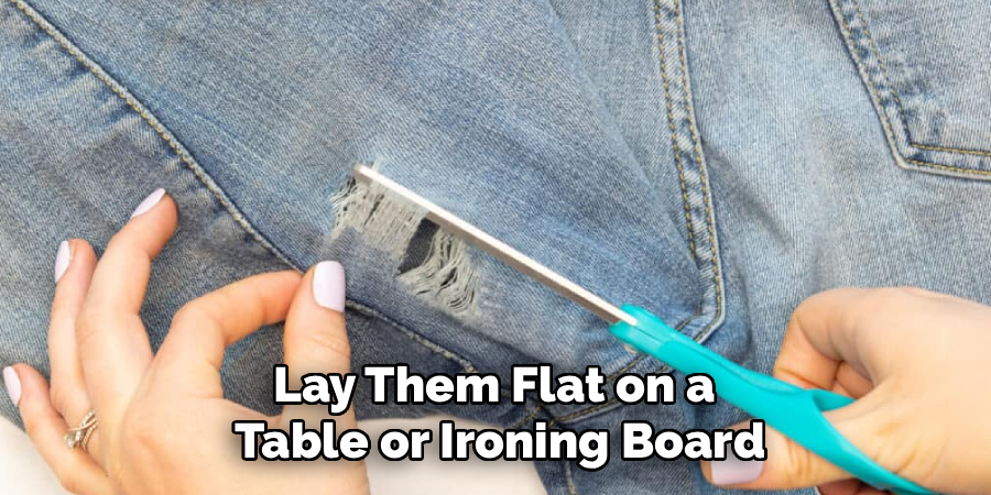 Lay Them Flat on a
Table or Ironing Board