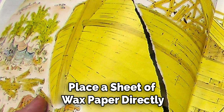 Place a Sheet of
Wax Paper Directly