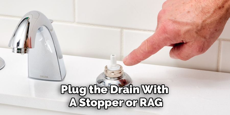 Plug the Drain With
A Stopper or RAG