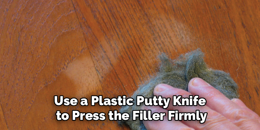 Use a Plastic Putty Knife
to Press the Filler Firmly